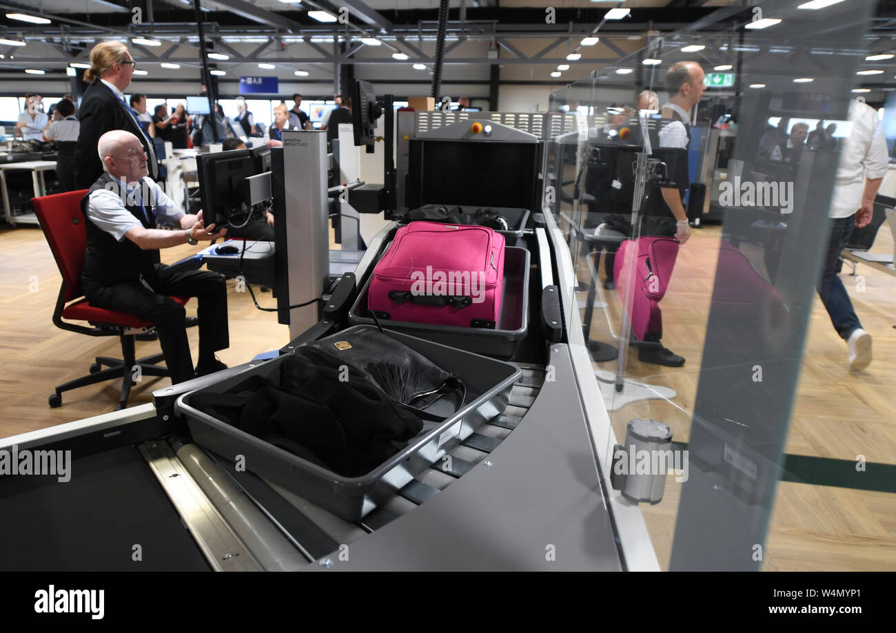 24 July 2019, Hessen, Frankfurt/Main: The hand luggage of passengers travelling by air is transported to a baggage scanner in a newly constructed hall in Terminal 1 of Frankfurt Airport at passenger screening. The seven new control lanes are intended to ensure smoother operation. Thanks to a new configuration, more passengers per hour can be guided through than with the technology previously used. Photo: Arne Dedert/dpa Stock Photo