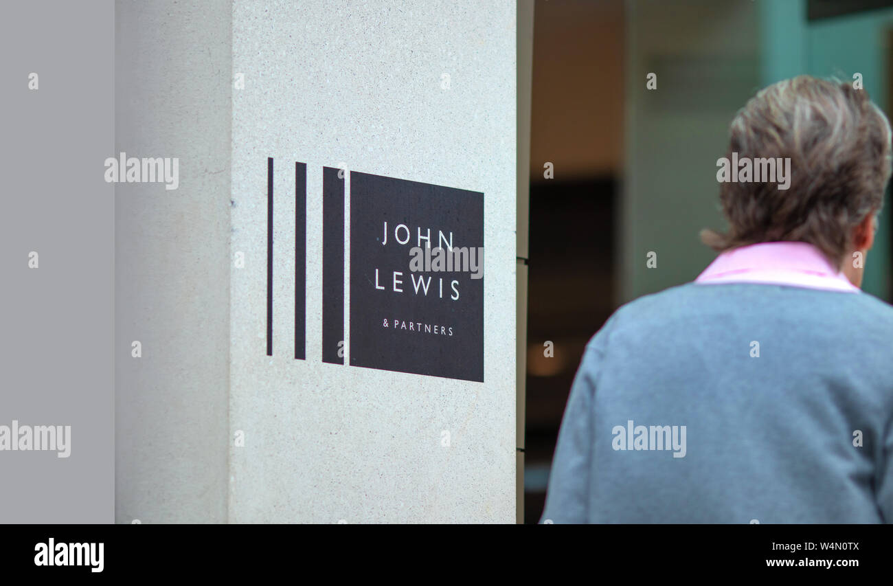 Mature woman enters the newly opened premium department store John