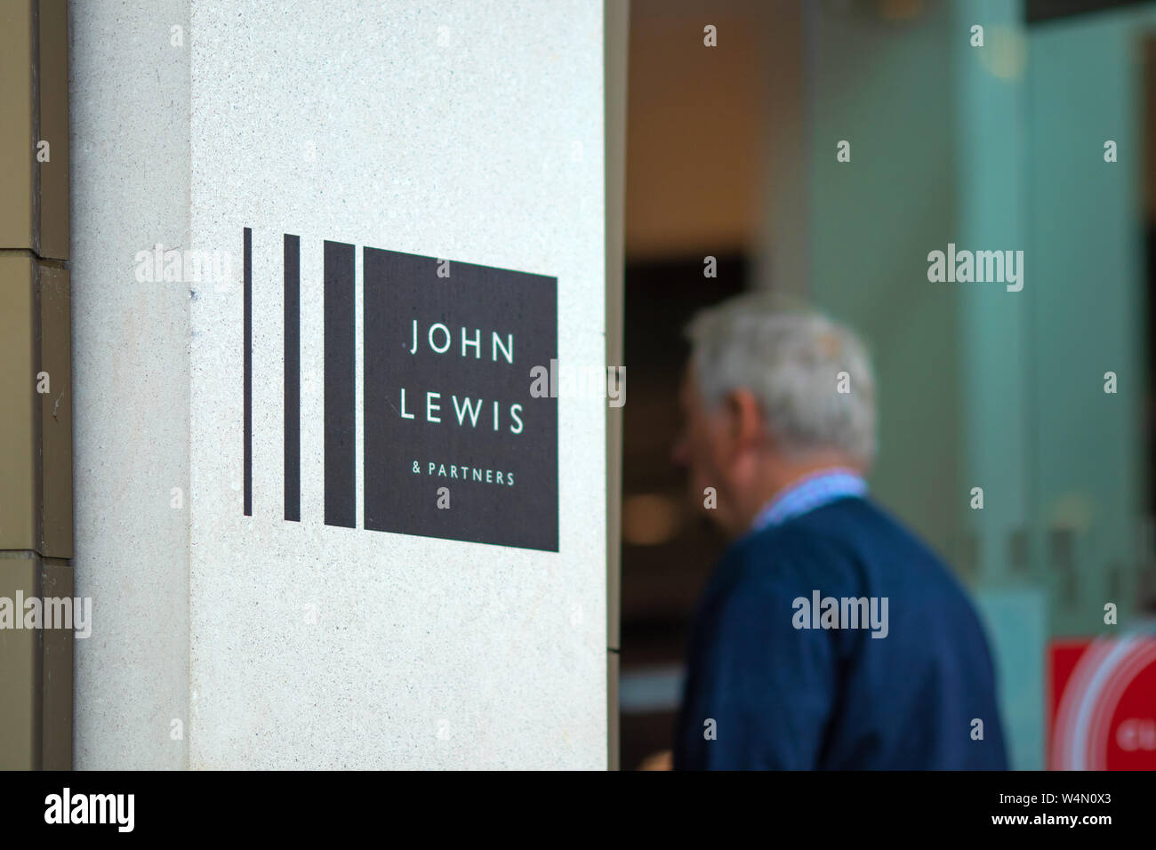Mature man enters the newly opened premium department store John Lewis