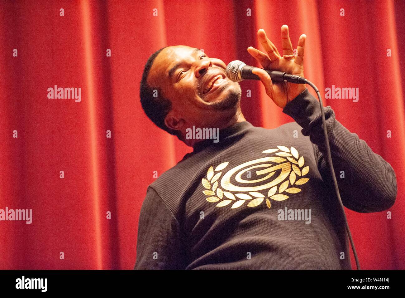 Low-angle close-up of actor and comedian David Alan Grier, making a face while speaking into a microphone at a Milton S Eisenhower Symposium at the Johns Hopkins University, Baltimore, Maryland, October 31, 2008. From the Homewood Photography Collection. () Stock Photo