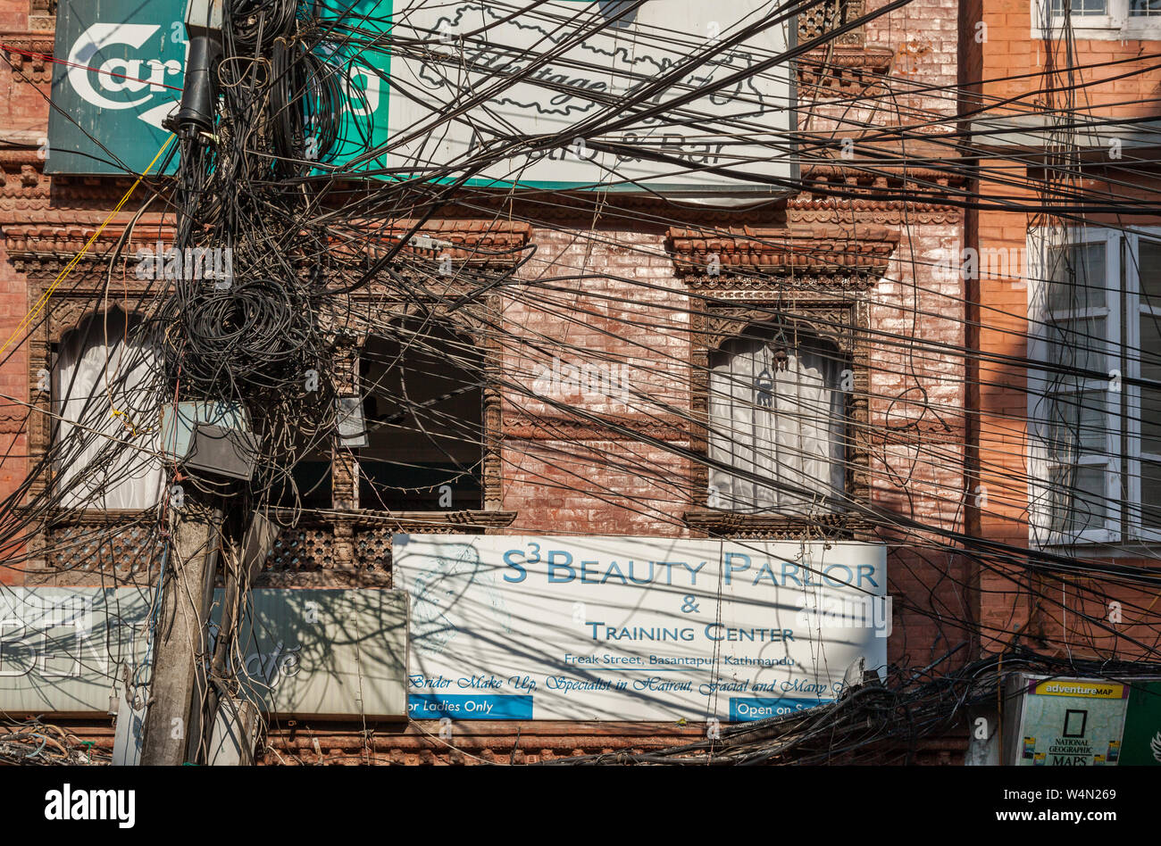 Mass of cables spreading out from a pole on a street in Kathmandu Stock Photo
