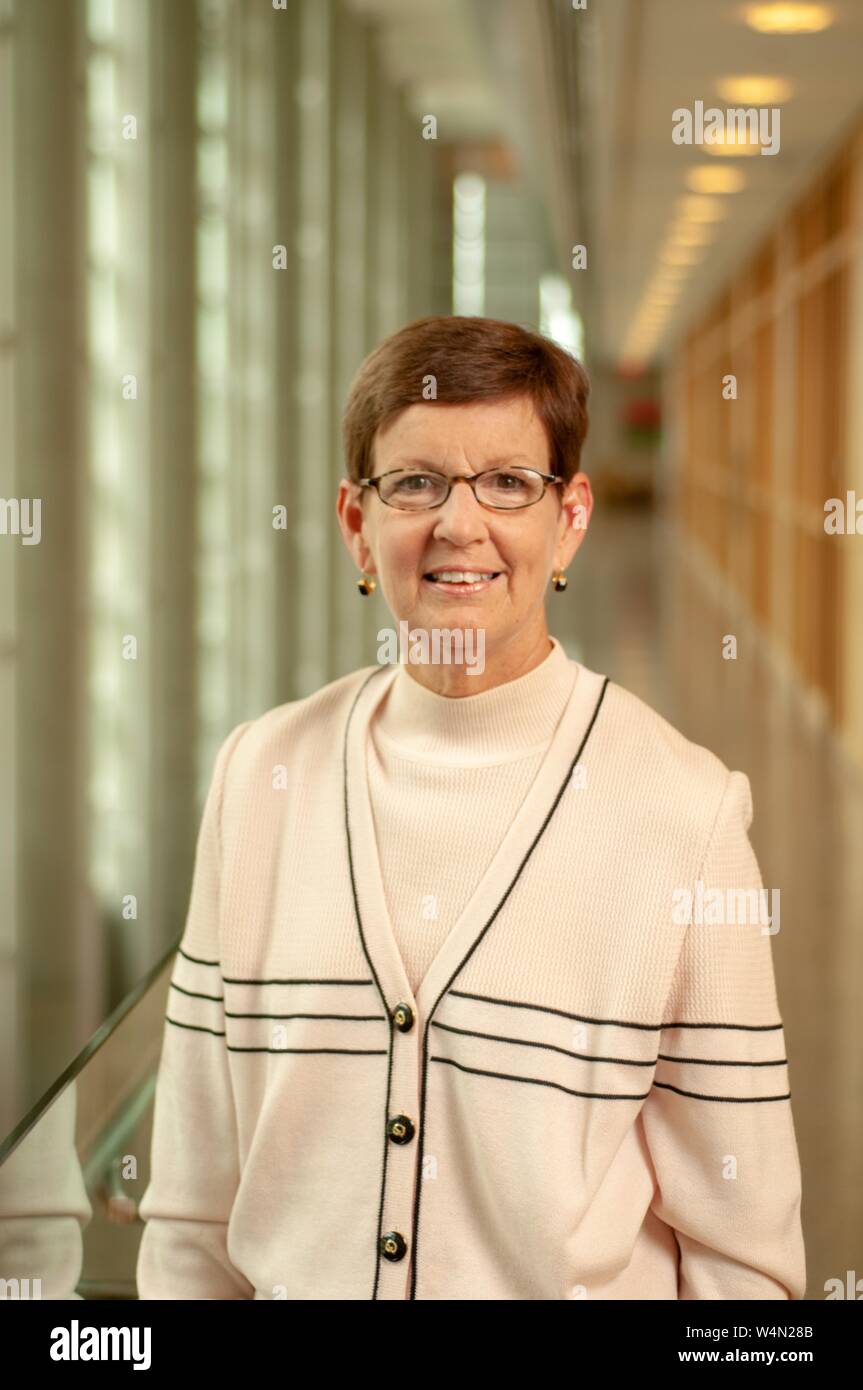 Close-up of Stephanie Reel, Chief Information Officer at the Johns Hopkins University in Baltimore, Maryland, standing in a hallway and smiling at the camera, August 30, 2007. From the Homewood Photography Collection. () Stock Photo