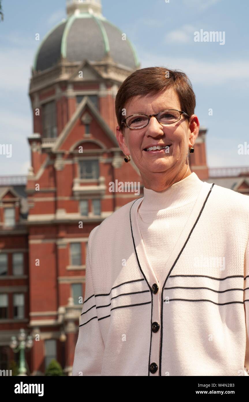 Low-angle close-up of Stephanie Reel, Chief Information Officer at the Johns Hopkins University in Baltimore, Maryland, standing outside on a sunny day and smiling at the camera, August 30, 2007. From the Homewood Photography Collection. () Stock Photo