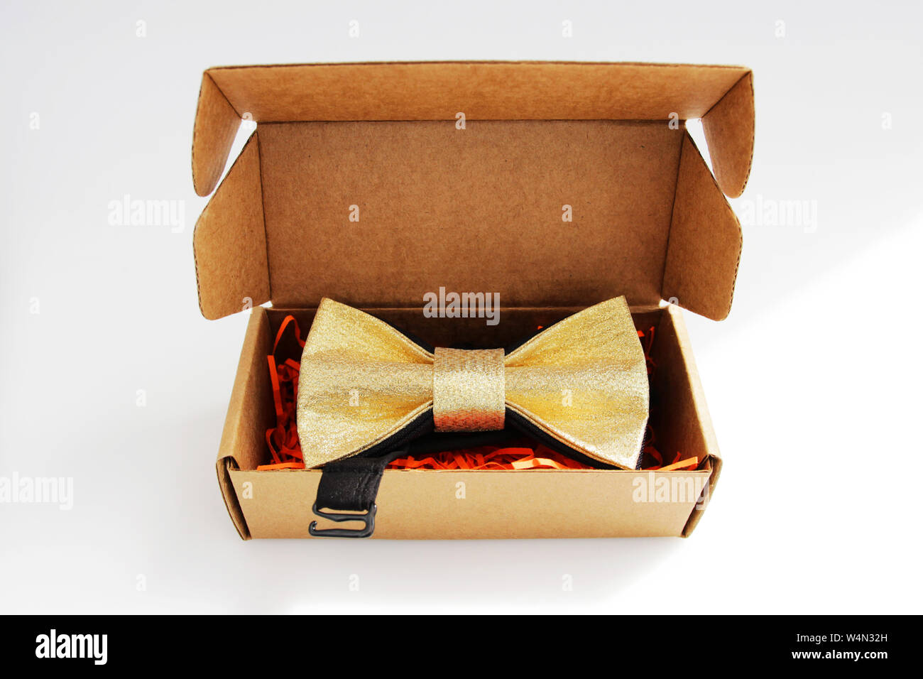 bow tie in a cardboard gift box. color gold. Stock Photo