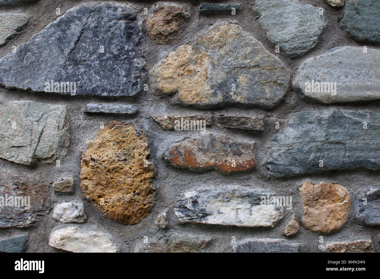 wall made using river boulders, Italian alps Stock Photo