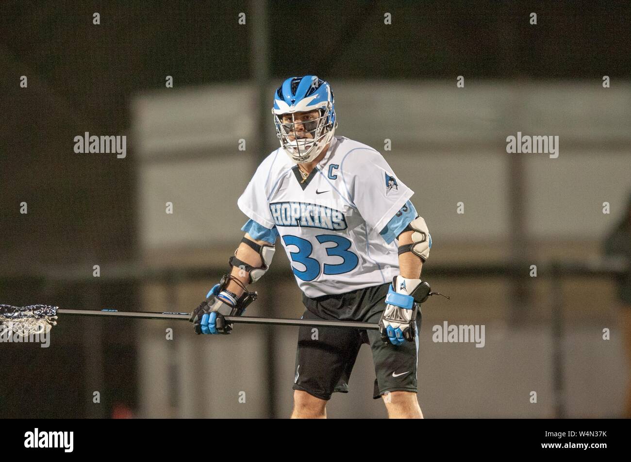 A Johns Hopkins Blue Jays Men's Lacrosse player stands ready with his stick while participating in a game at the Johns Hopkins University, Baltimore, Maryland, February 20, 2009. From the Homewood Photography Collection. () Stock Photo