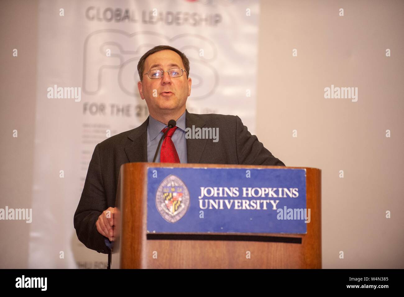 Low angle view of journalist David E Sanger, standing behind a podium while speaking during a Foreign Affairs Symposium at the Johns Hopkins University, Baltimore, Maryland, March 3, 2009. From the Homewood Photography Collection. () Stock Photo