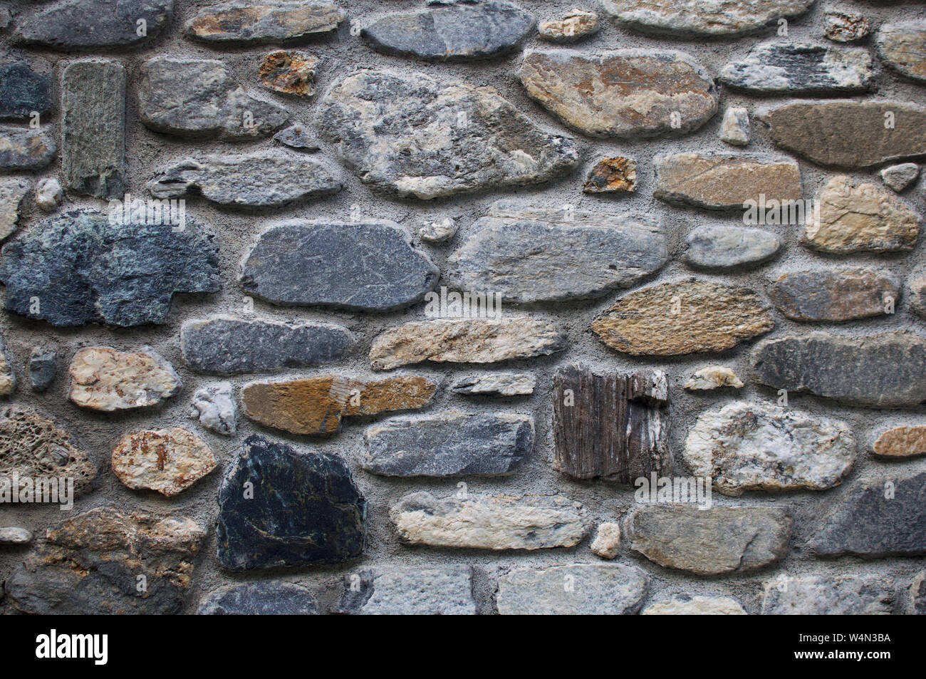 wall made using river boulders, Italian alps Stock Photo