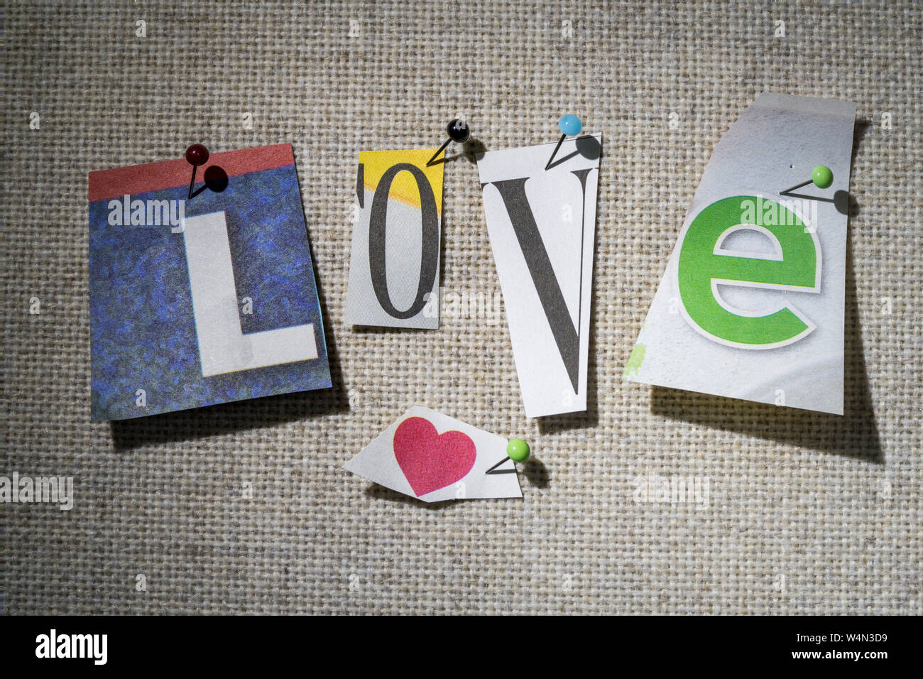 The word LOVE on a bulletin board using cut-out paper letters in