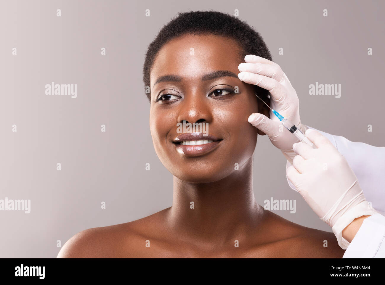 Beautiful black woman making plastic surgery procedure for face Stock Photo