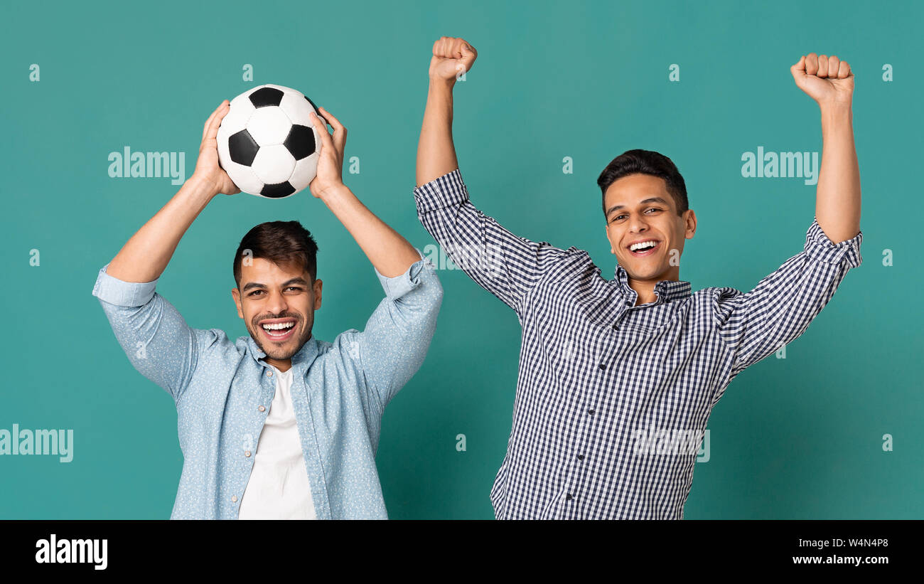 Two Soccer Fans Holding Ball And Celebrating Victory Stock Photo Alamy