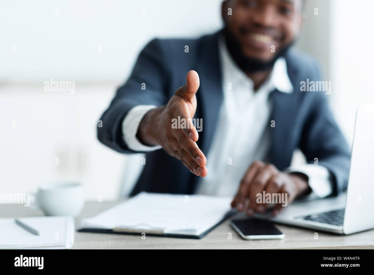 African American businessman extending hand to shake Stock Photo