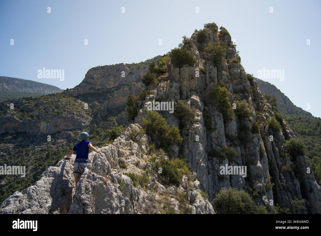 Man climbing towards the Hermitage of La Pertusa, Corça, Lleida, Spain Stock Photo