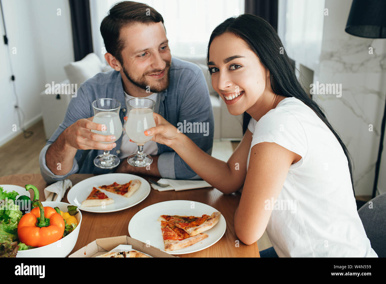 Happy couple have dinner with pizza at home. Its a good time spending home Stock Photo