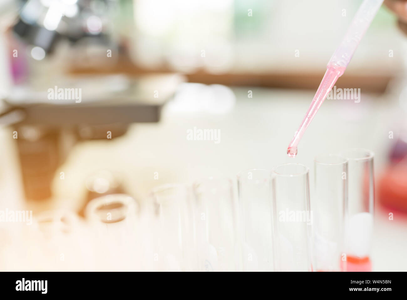 Doctor woman or chemist use dropper drop liquid chemical in to test