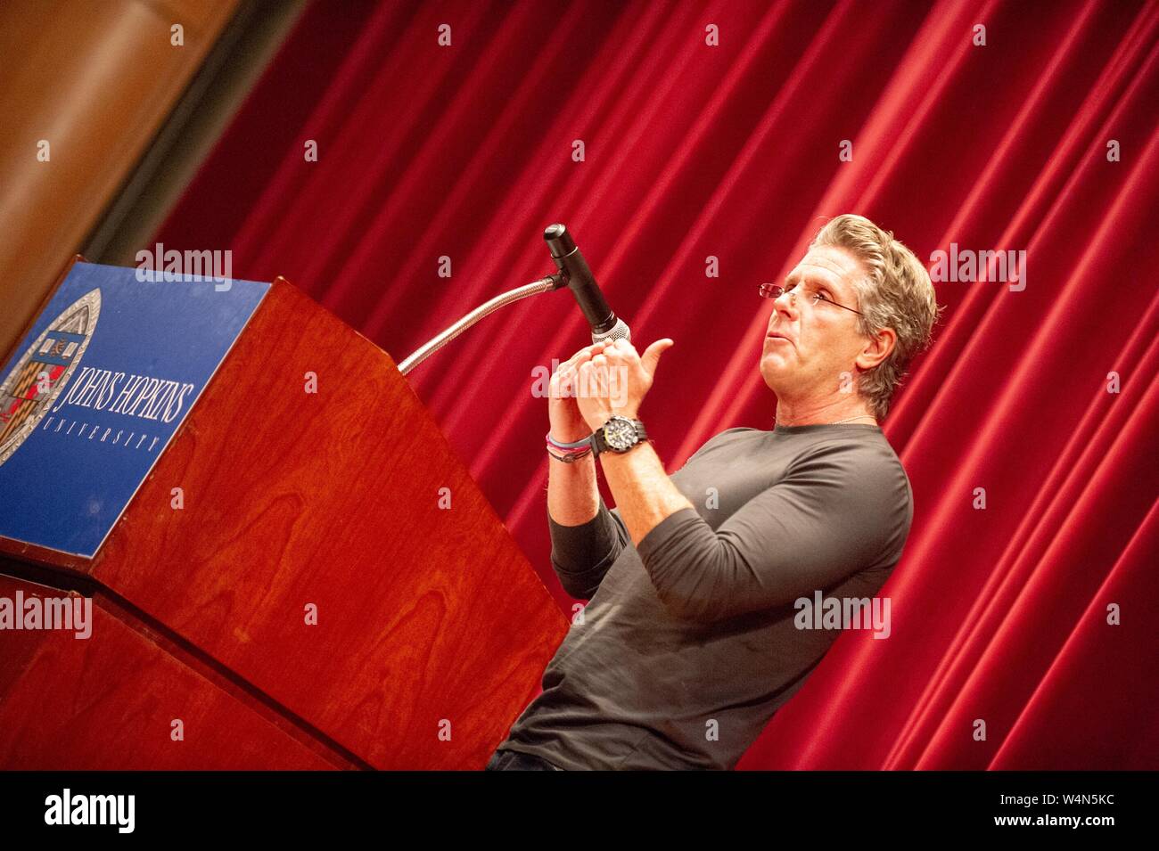 Angled profile view of Donny Deutsch, marketing professional and television personality, speaking at a Milton S Eisenhower Symposium at the Johns Hopkins University, Baltimore, Maryland, November 9, 2010. From the Homewood Photography Collection. () Stock Photo