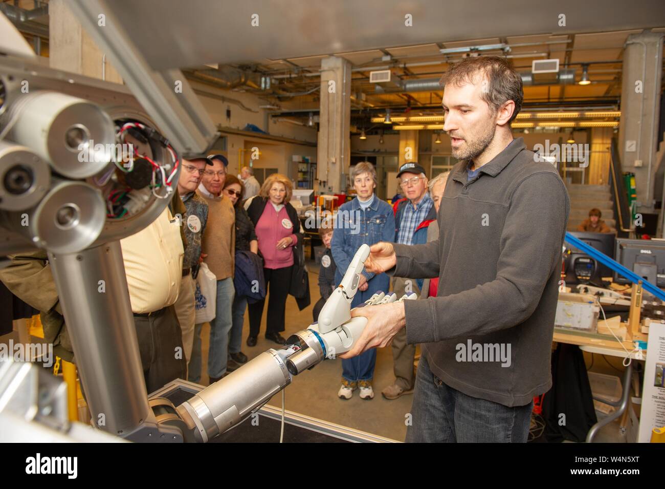 A person demonstrates robotics development laboratory equipment for a tour group visiting the Johns Hopkins University, Baltimore, Maryland, April 10, 2010. From the Homewood Photography Collection. () Stock Photo