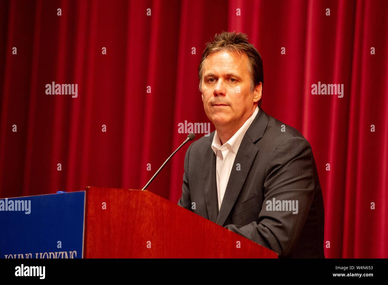 Richard Roeper, columnist and film critic, standing behind a podium during a Milton S Eisenhower Symposium at the Johns Hopkins University, Baltimore, Maryland, October 5, 2010. From the Homewood Photography Collection. () Stock Photo