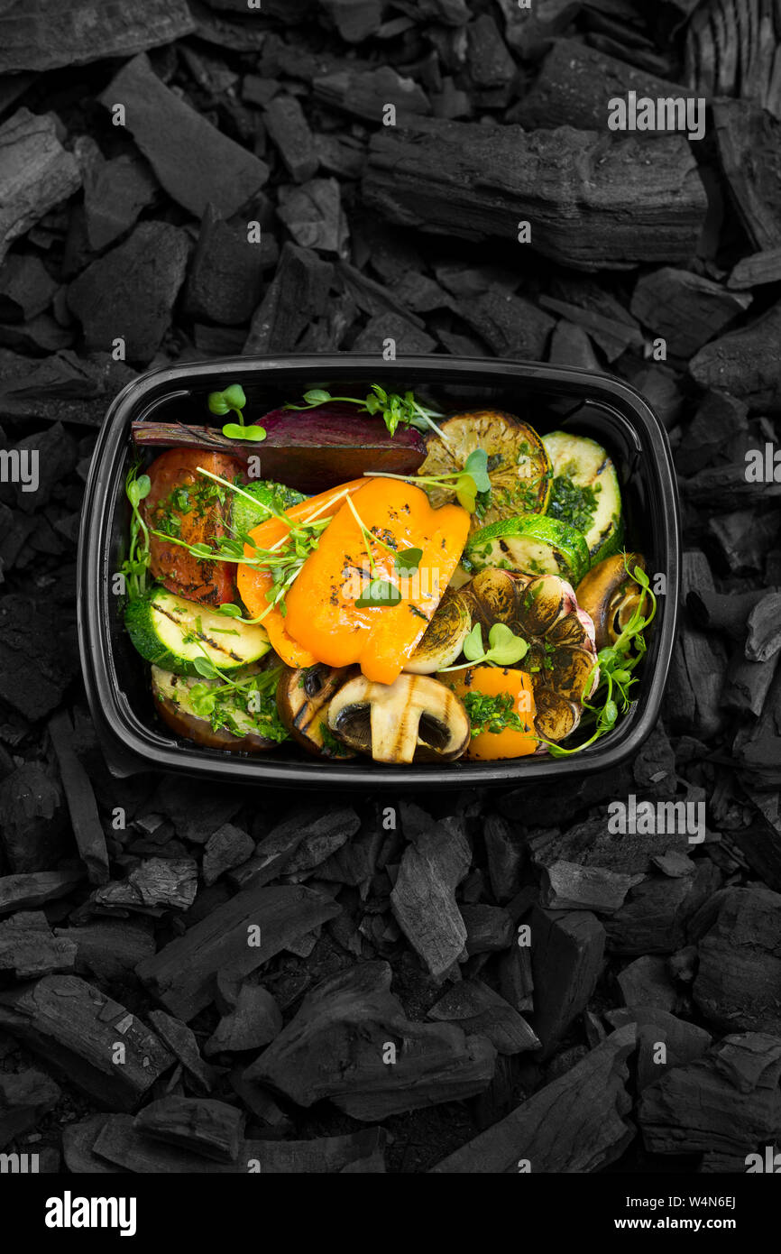 Grilled cooked vegetables in black take away box Stock Photo