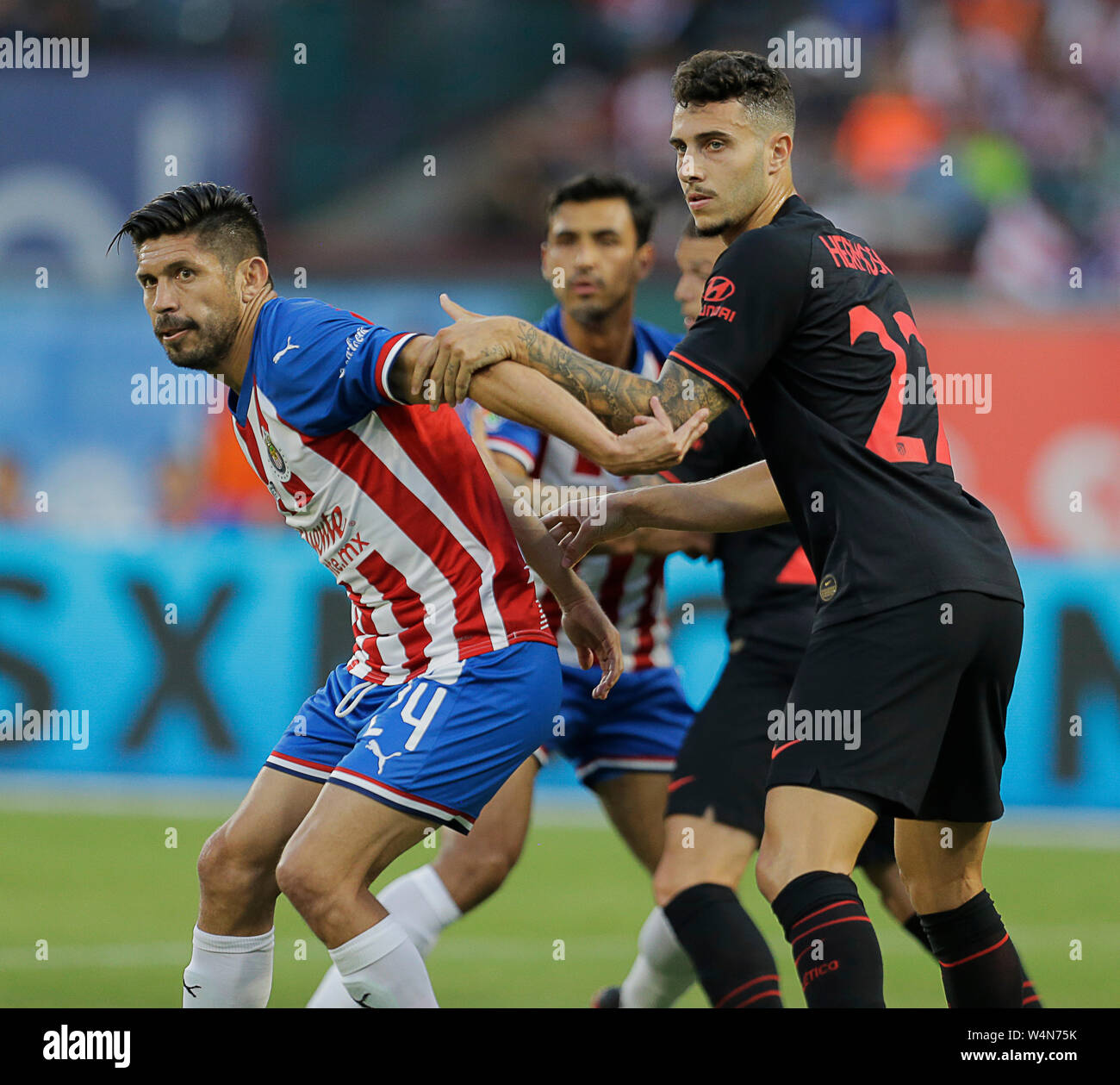 Arlington, Texas, USA. 23rd July, 2019. July 23, 2019, Arlington, Texas, United States; Oribe Peralta (24) and Mano Hermosa (22) fight for position on a corner kick during the International Champions Cup match between Chivas de Guadalajara and AtlÅ½tico de Madrid at Globe Life Park in Arlington, Tx. Credit: Ralph Lauer/ZUMA Wire/Alamy Live News Stock Photo