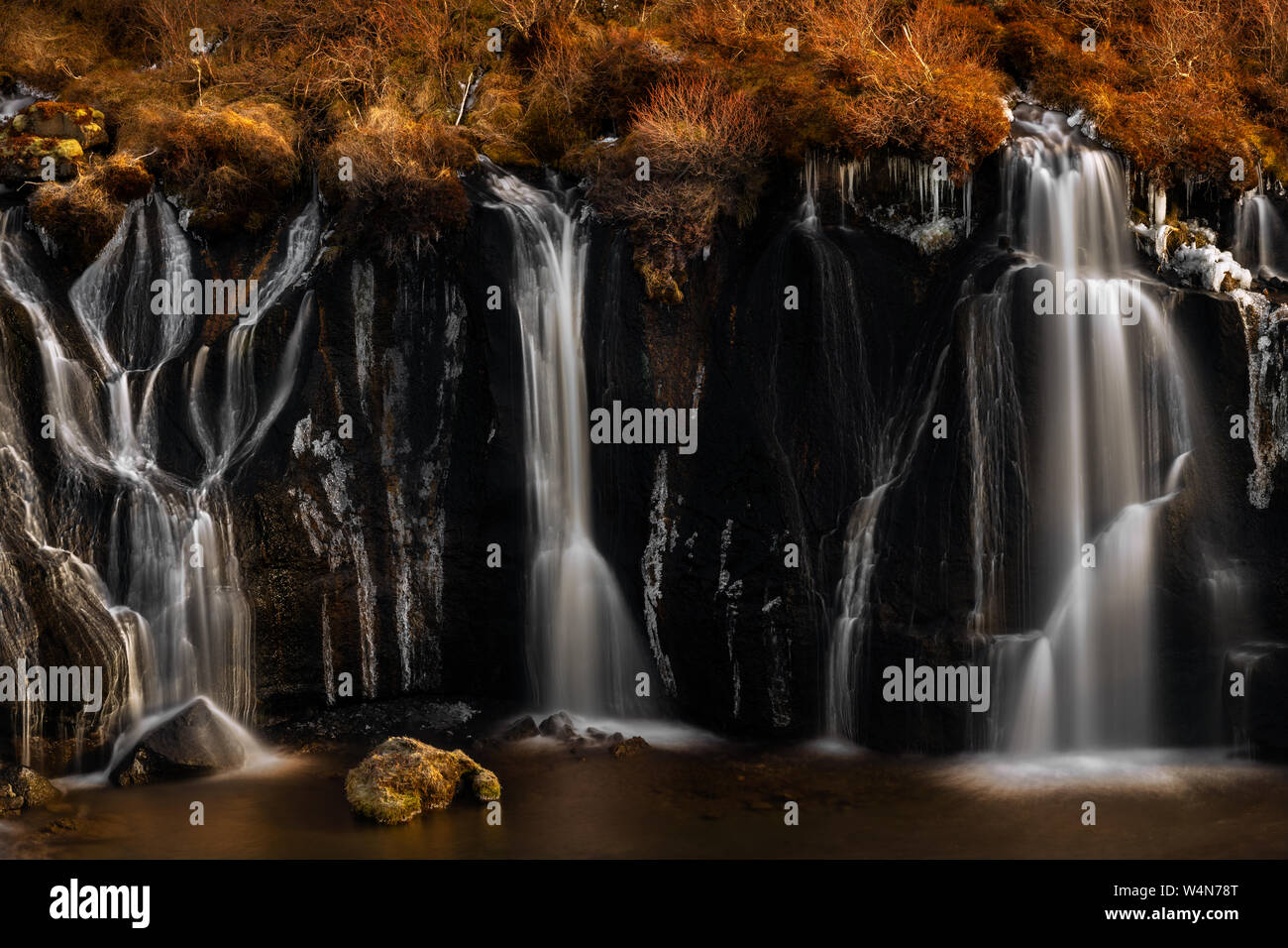 Hraunfossar is the famous waterfall coming out of a lava field. Stock Photo