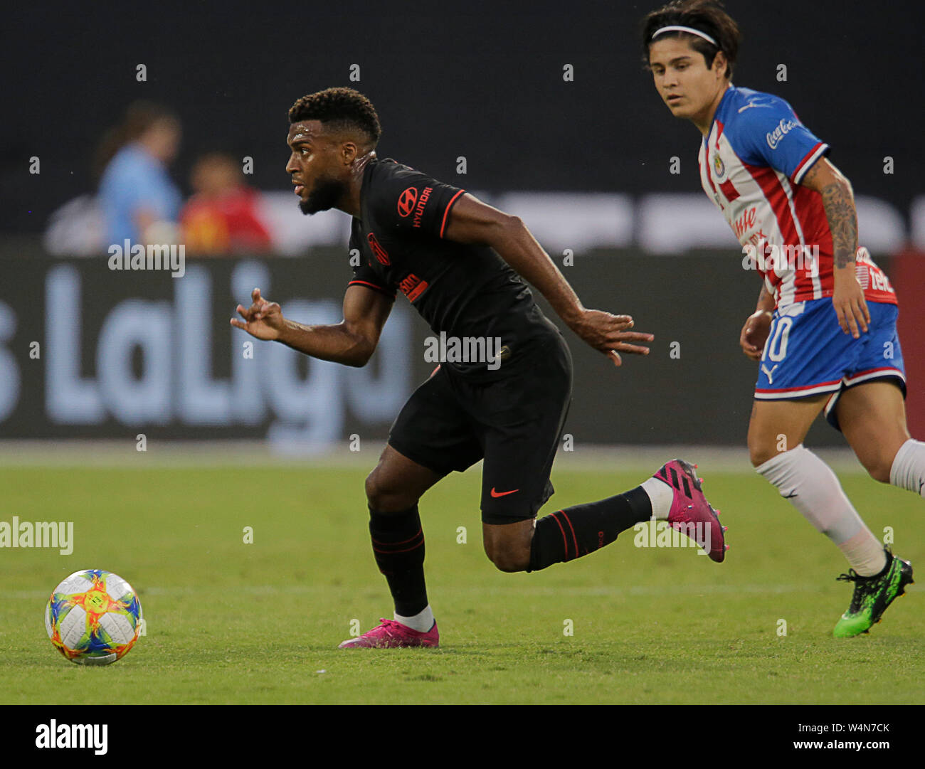 Arlington, Texas, USA. 23rd July, 2019. July 23, 2019, Arlington, Texas, United States; Thomas Lemar (11) escapes Javier Lopez (10) during the first half of the International Champions Cup match between Chivas de Guadalajara and AtlÅ½tico de Madrid at Globe Life Park in Arlington, Tx. Credit: Ralph Lauer/ZUMA Wire/Alamy Live News Stock Photo