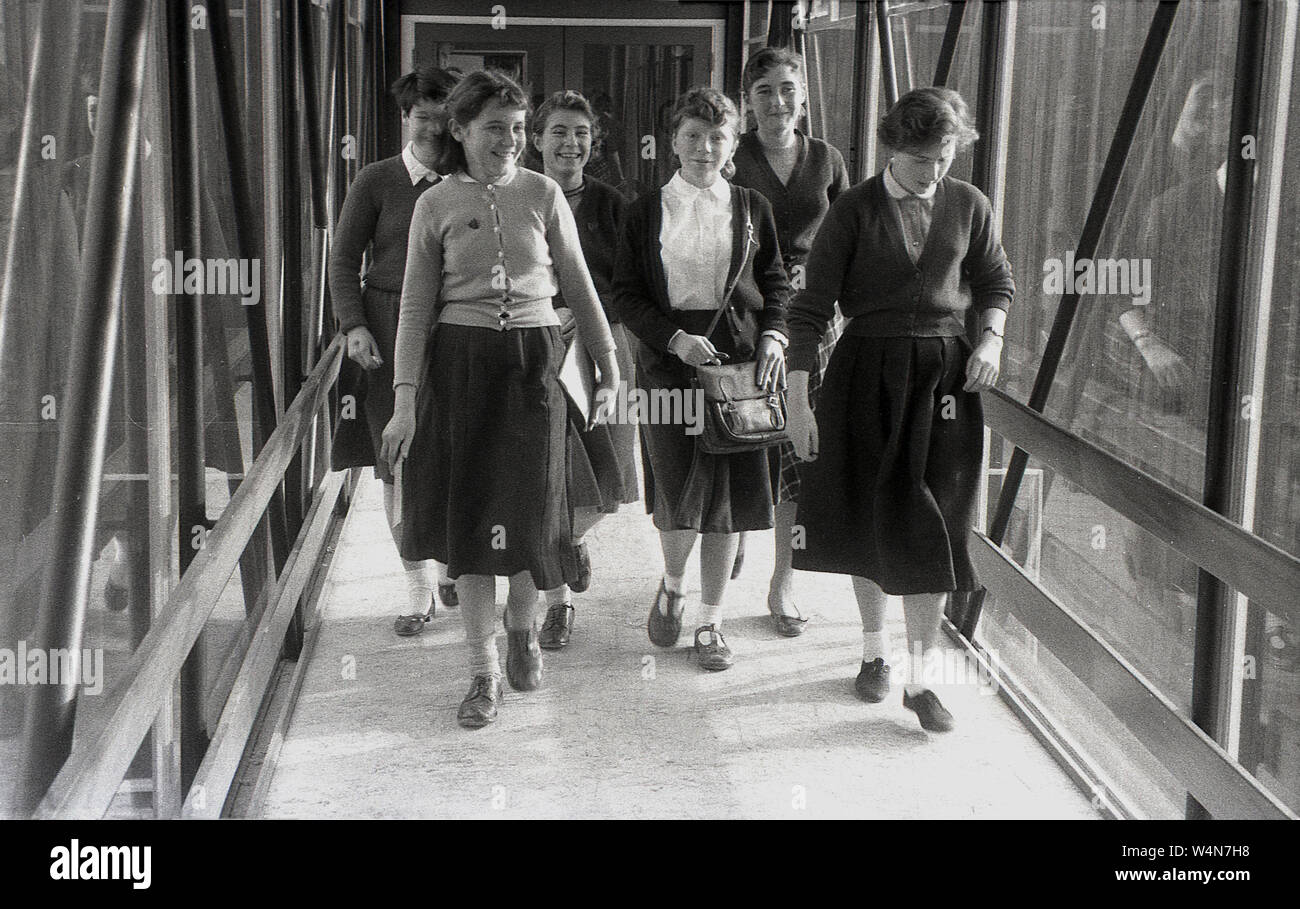 1950s, historical, group of school girls walking through a crossing area between classrooms at a British county secondary school, England, UK. Stock Photo