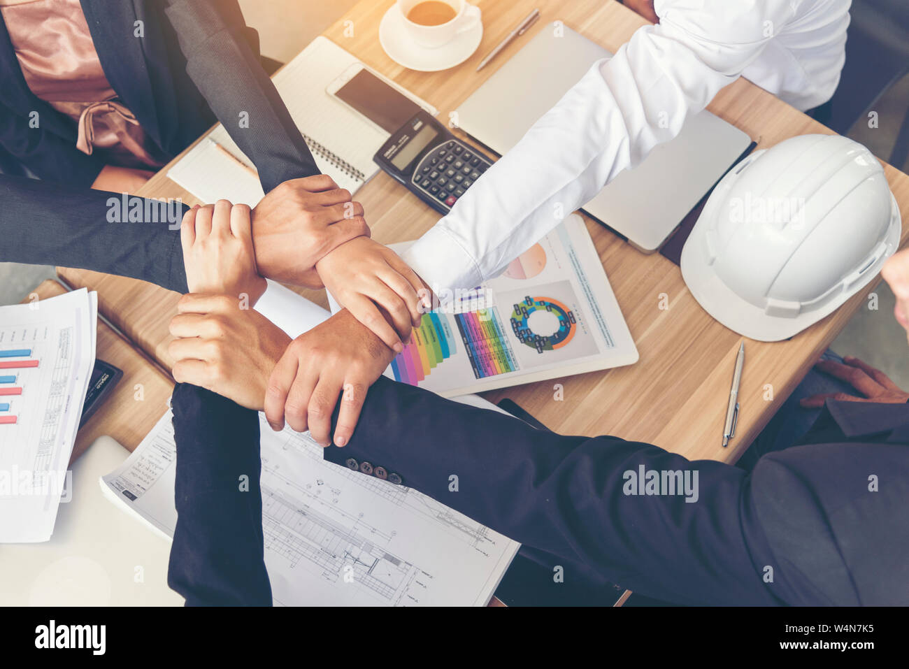Businessman and engineer working  hands of business people join hand together. Teamwork Concept. Stock Photo