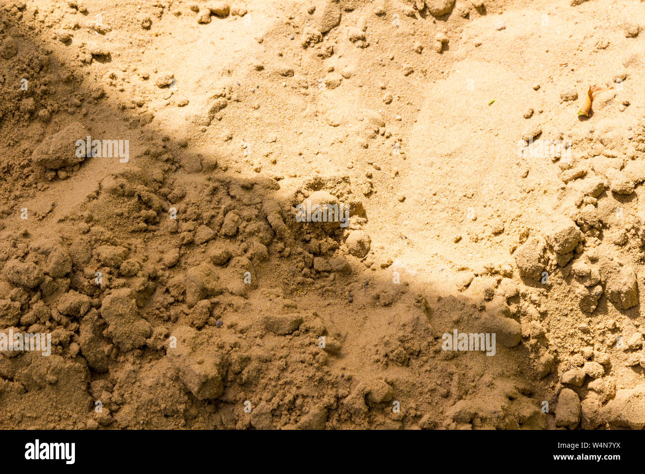 Yellow sand at beach with diagonal shadow Stock Photo