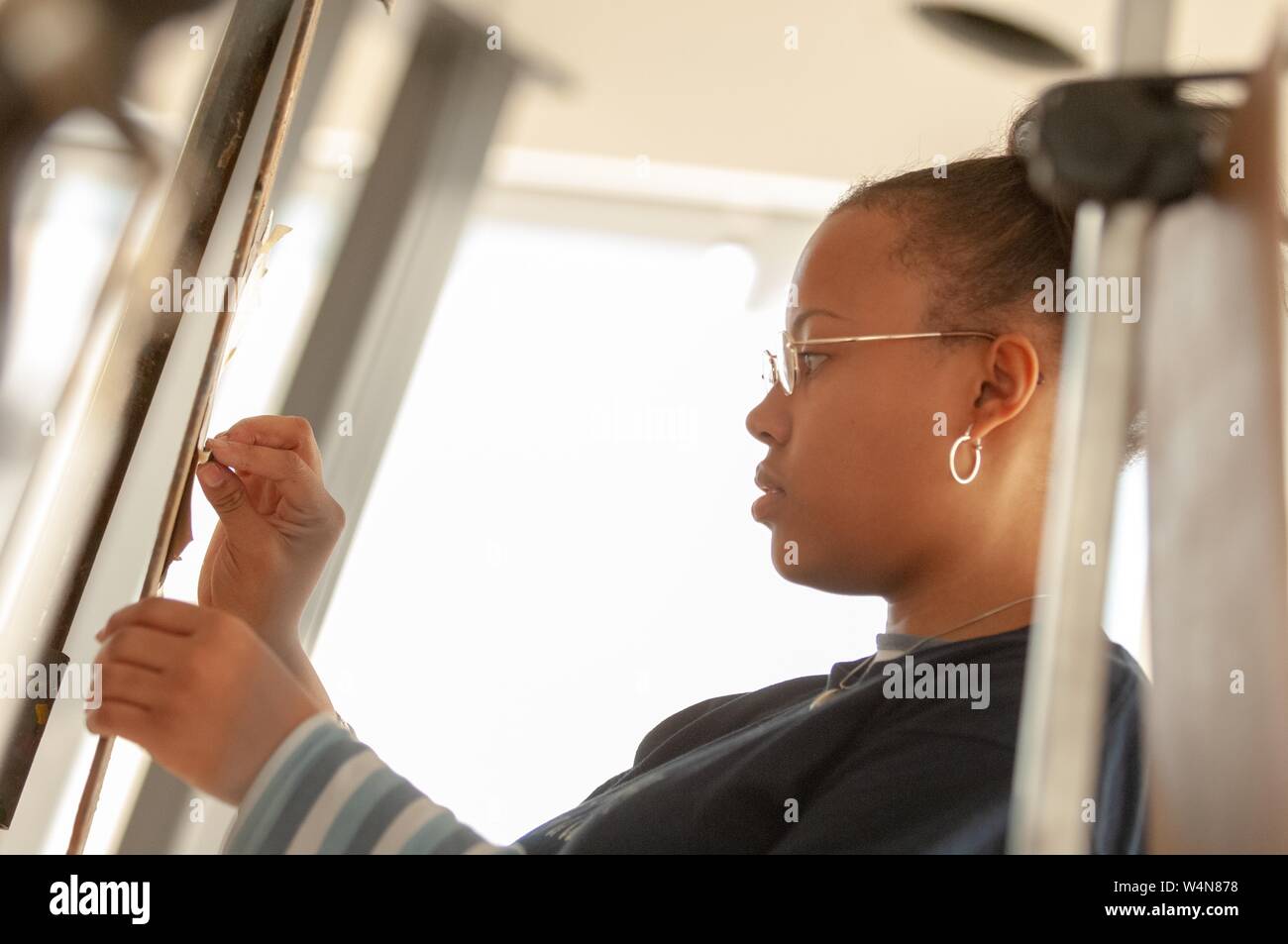 Profile shot of an artist, working on a project in a studio at the Mattin Center, at the Johns Hopkins University, Baltimore, Maryland, February 6, 2006. From the Homewood Photography Collection. () Stock Photo
