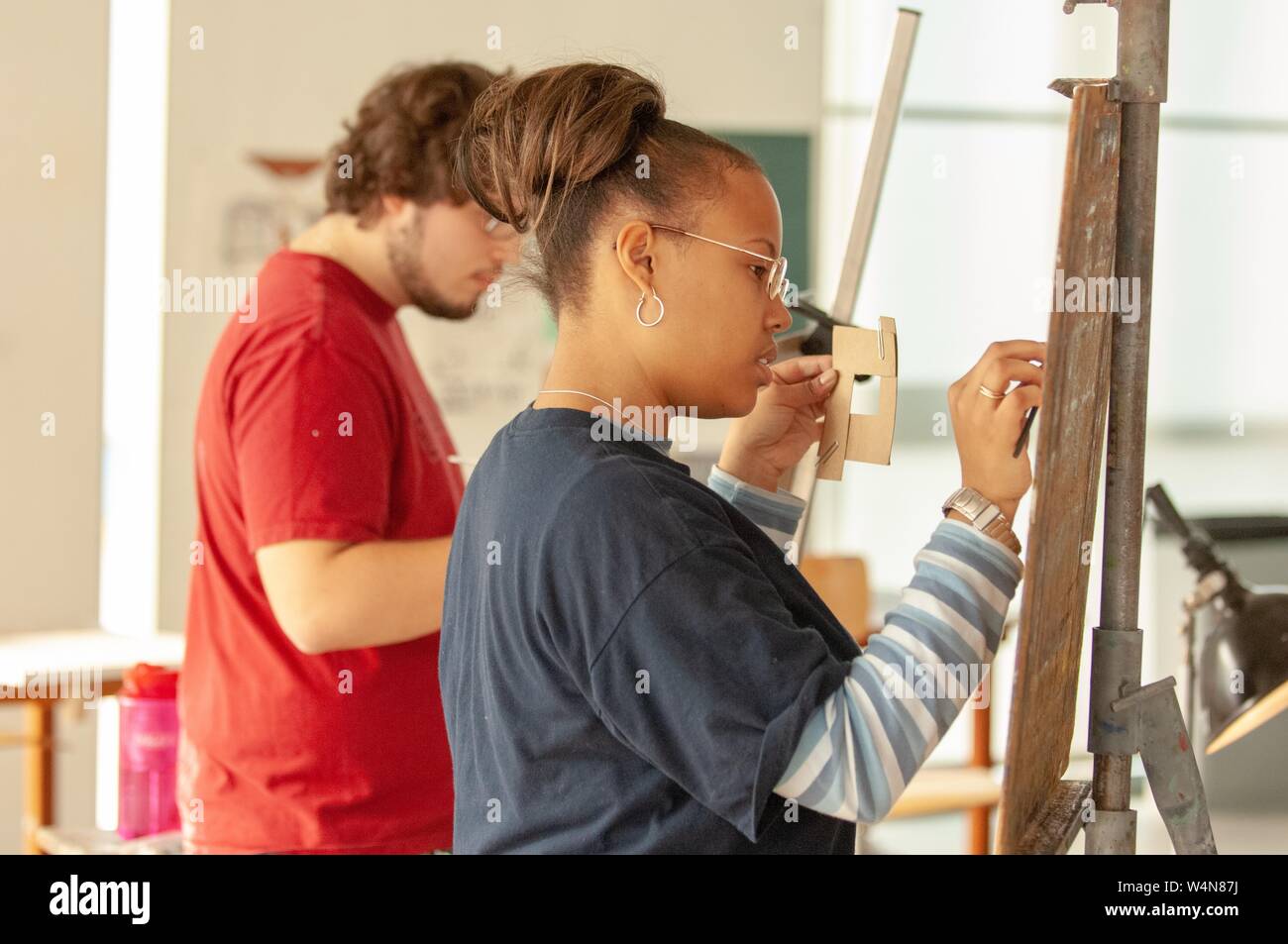 Profile shot of two artists, working on projects in a studio space at the Mattin Center, at the Johns Hopkins University, Baltimore, Maryland, February 6, 2006. From the Homewood Photography Collection. () Stock Photo
