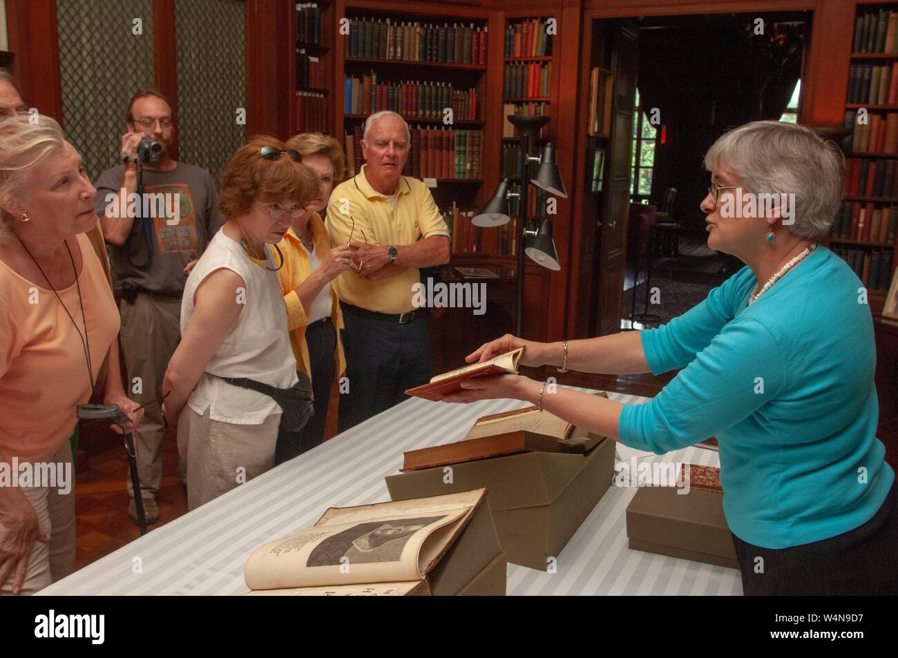 A staff member exhibits antique books, including a 1685 copy of Shakespeare's plays, from the Milton S Eisenhower Library's collection, at the Johns Hopkins University, Baltimore, Maryland, July 23, 2006. From the Homewood Photography Collection. () Stock Photo