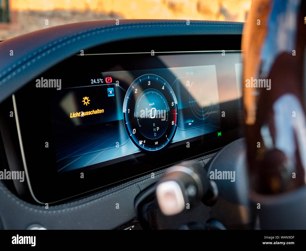 Luxury car dashboard with sunset reflections in the glass, warm colors