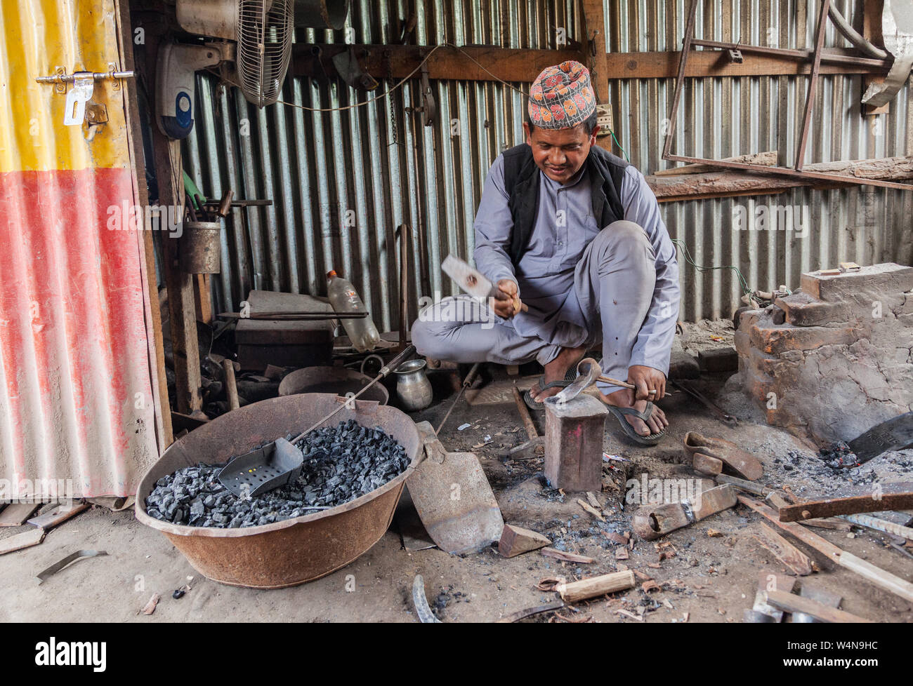 A metal worker in his forge in Nepal Stock Photo