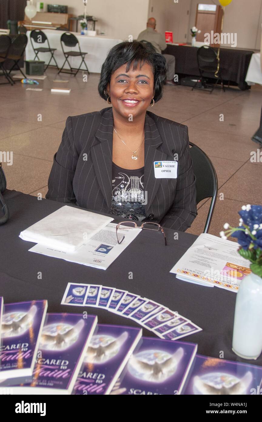 Author Valerie Opher sits at a table displaying her publication 'Scared to Faith, ' during an African-American Book Festival at the Johns Hopkins University, Baltimore, Maryland, May 6, 2006. From the Homewood Photography Collection. () Stock Photo