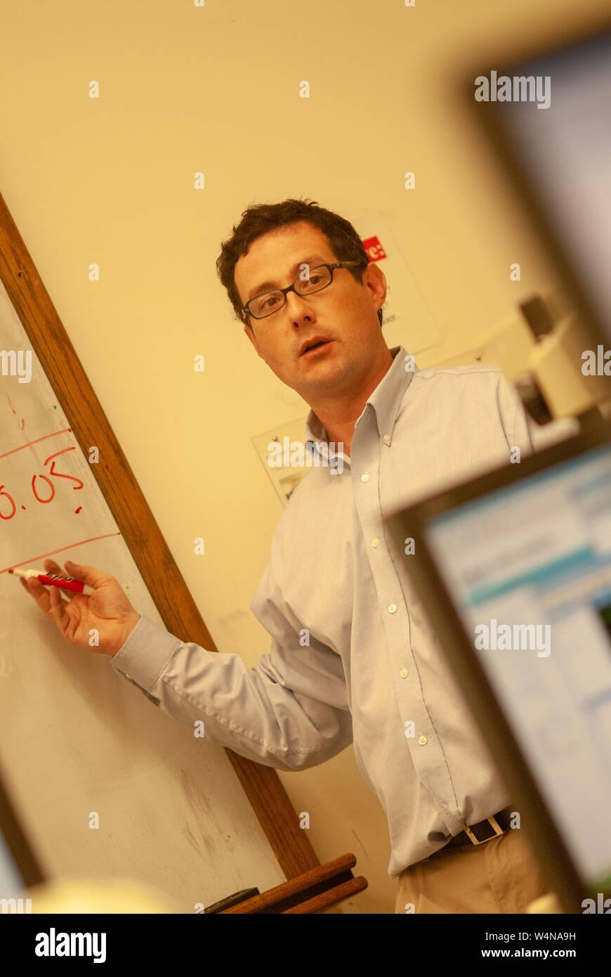 Angled mid-shot of Robert Lessick, Program Director for the Master of Science in Bioinformatics, using a whiteboard at the Johns Hopkins University, Baltimore, Maryland, February 26, 2007. From the Homewood Photography Collection. () Stock Photo