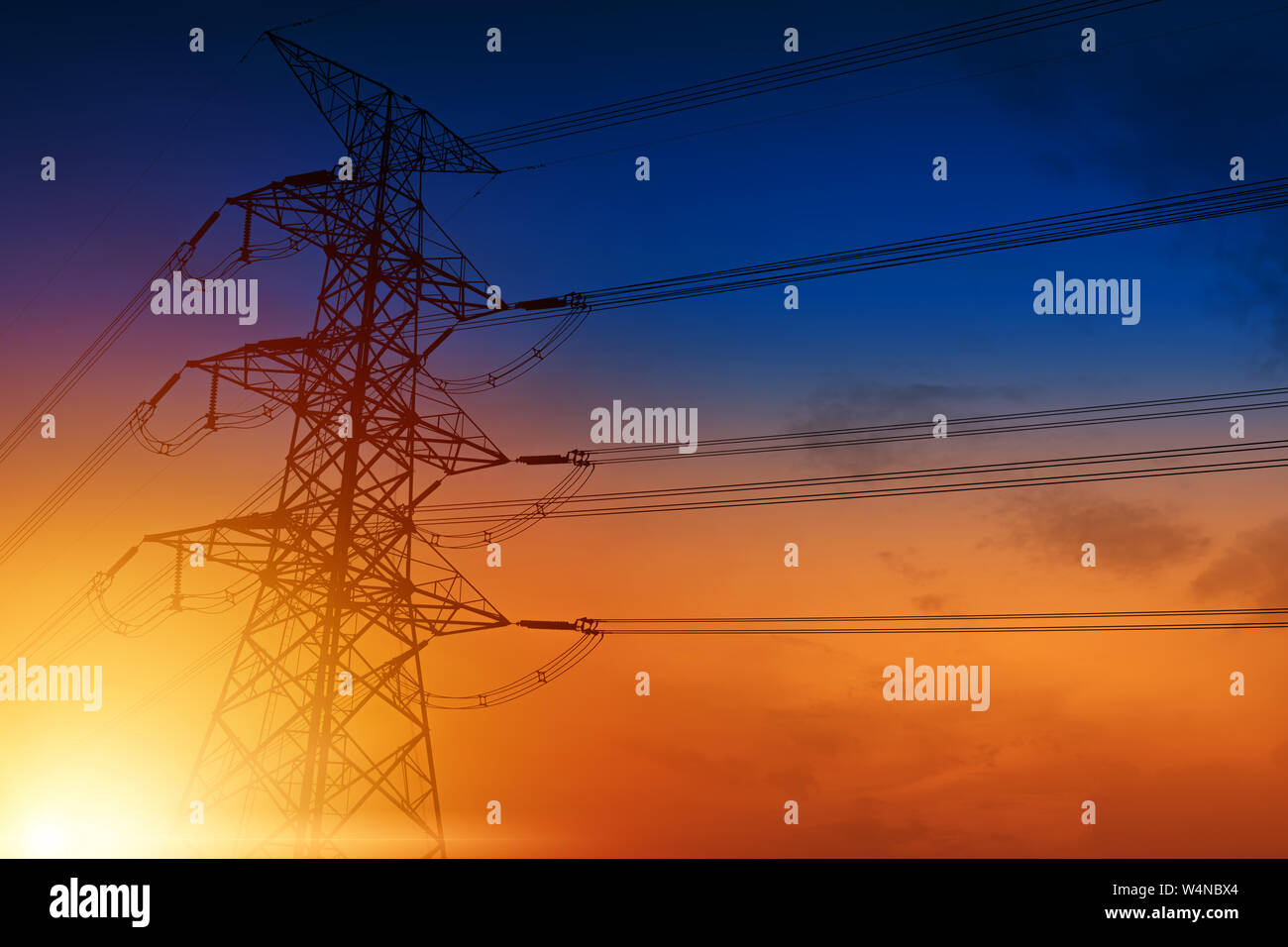 High voltage towers against the sunset background Stock Photo - Alamy
