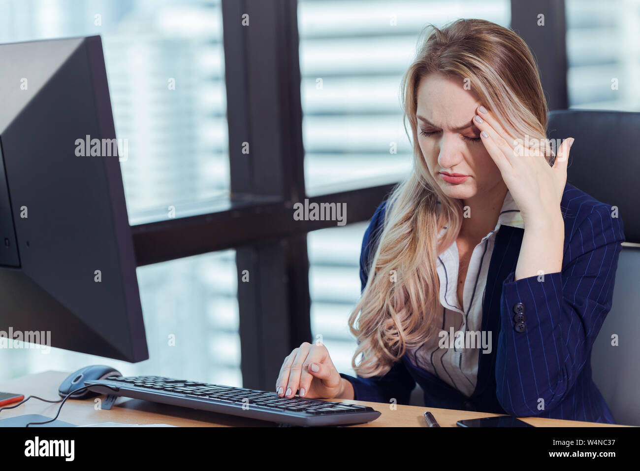 Office Worker or Businesswoman suffering headaches from computer screen Stock Photo