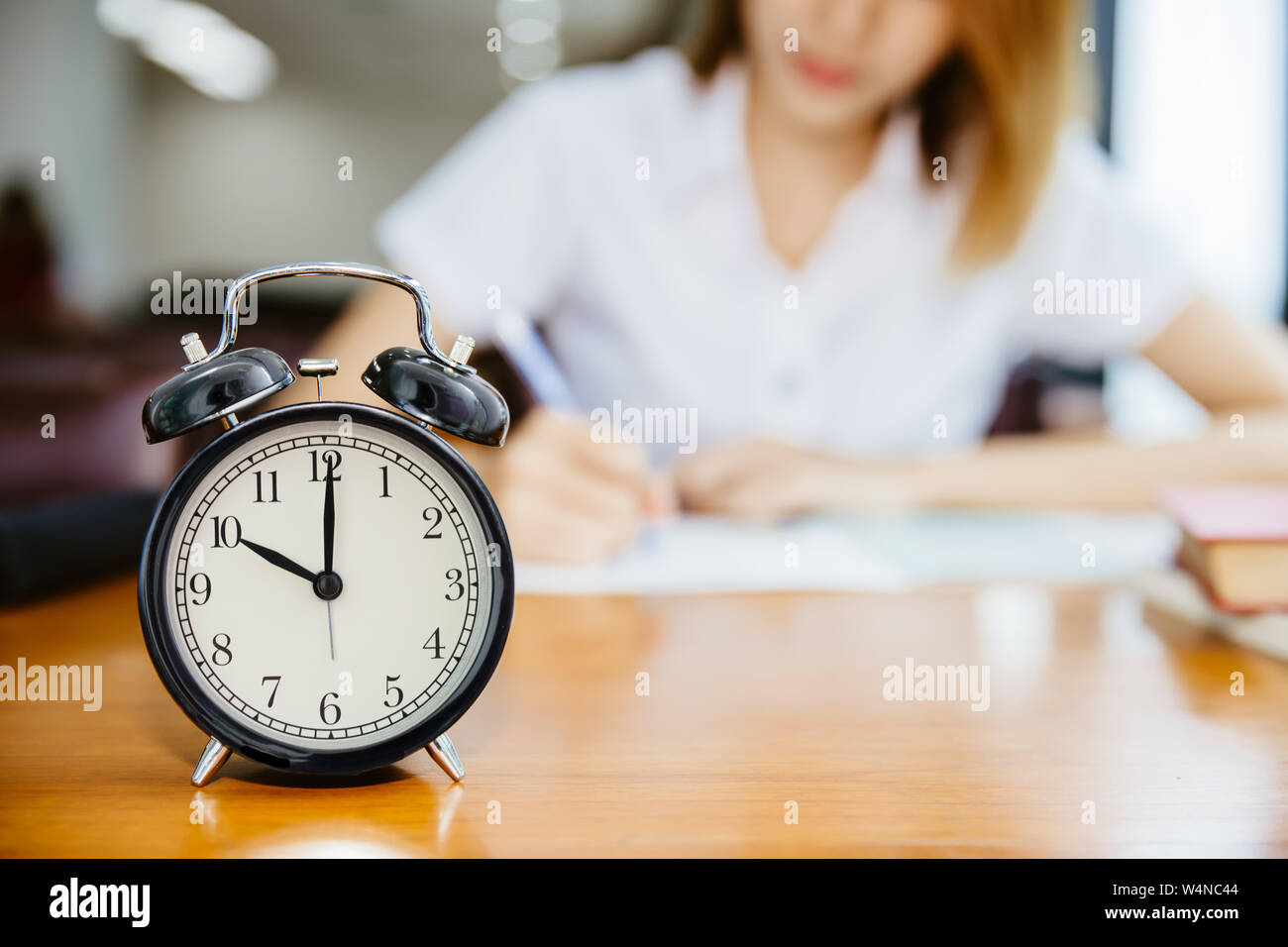 university girl teen working with times clock learn with attention concept Stock Photo