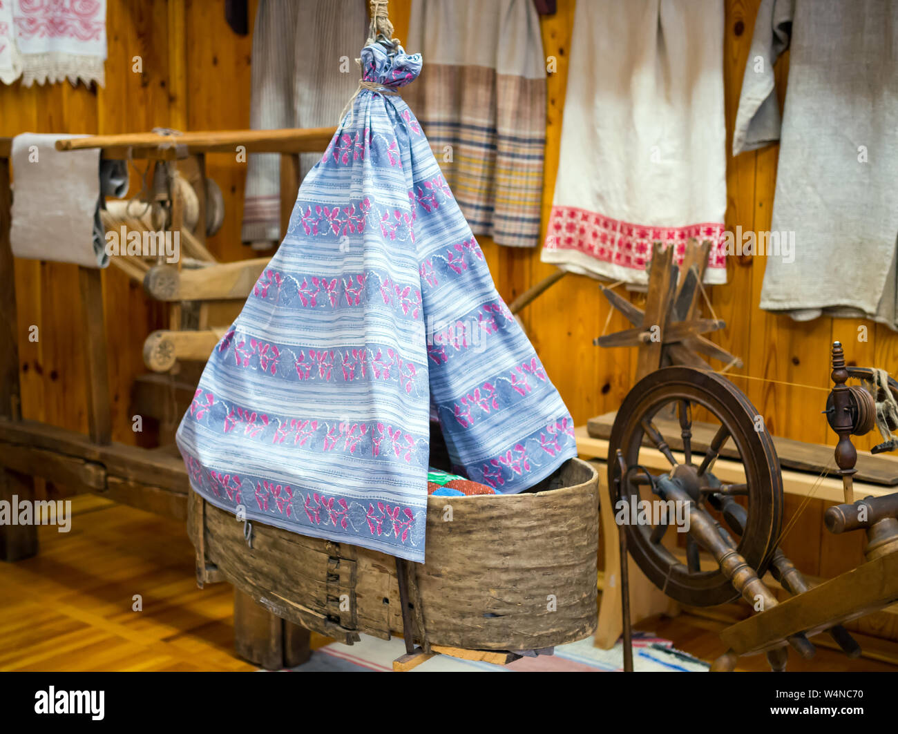 Antique wicker baby cradle in the interior of the hut Stock Photo