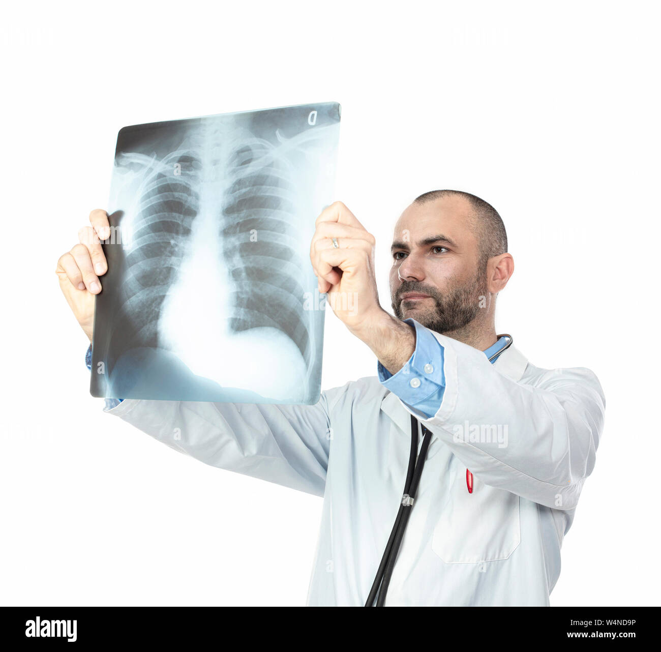 doctor with beard and gown examines a chest x-ray isolated on white. Stock Photo