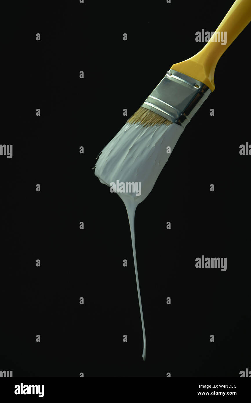 Dripping White Paint Brush On A Blackbackground Stock Photo Alamy