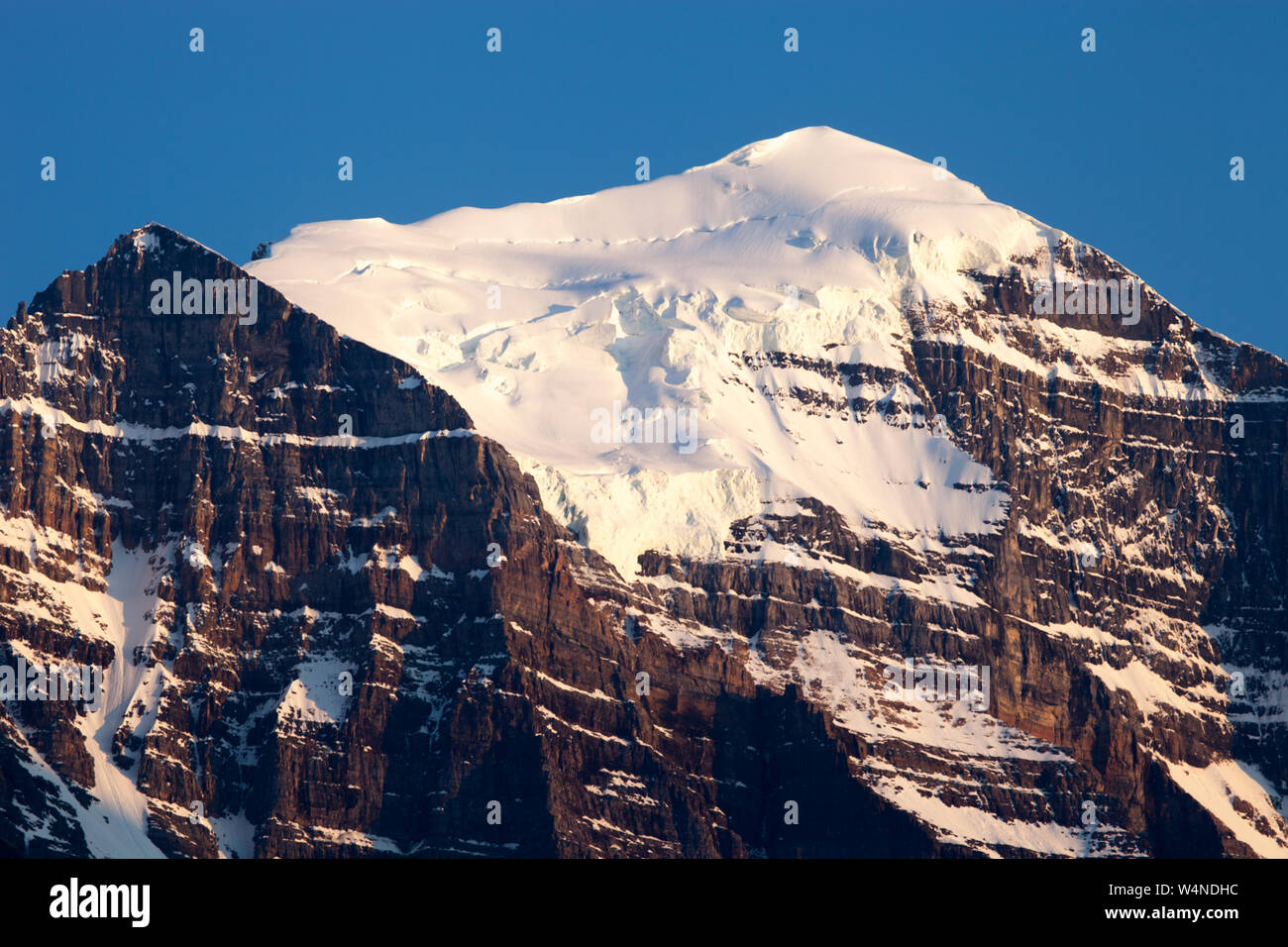Glacial ice on the summit of Mount Temple, made of Cambrian age quartzite of the Gog Group, Banff National Park, Alberta, Canada Stock Photo