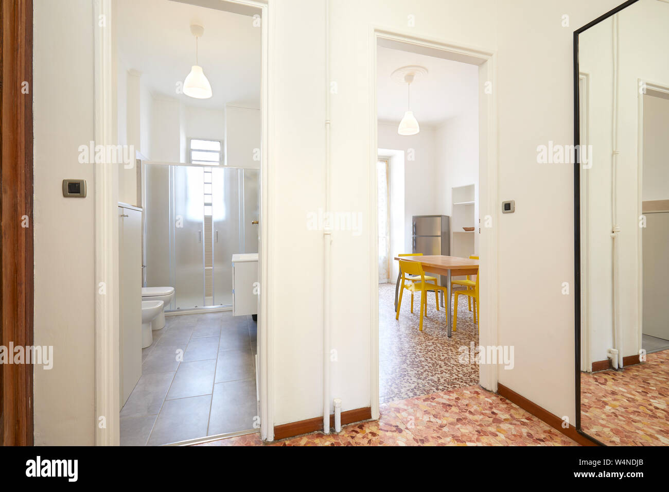 Apartment entrance in renovated interior with bathroom and kitchen Stock Photo