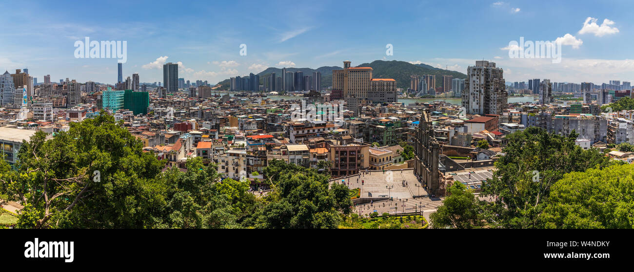 Panorama view on Skyline of Macau inside vegetation, Ruins of St. Paul's in foreground and China in background. Santo António, Macao, China. Asia. Stock Photo
