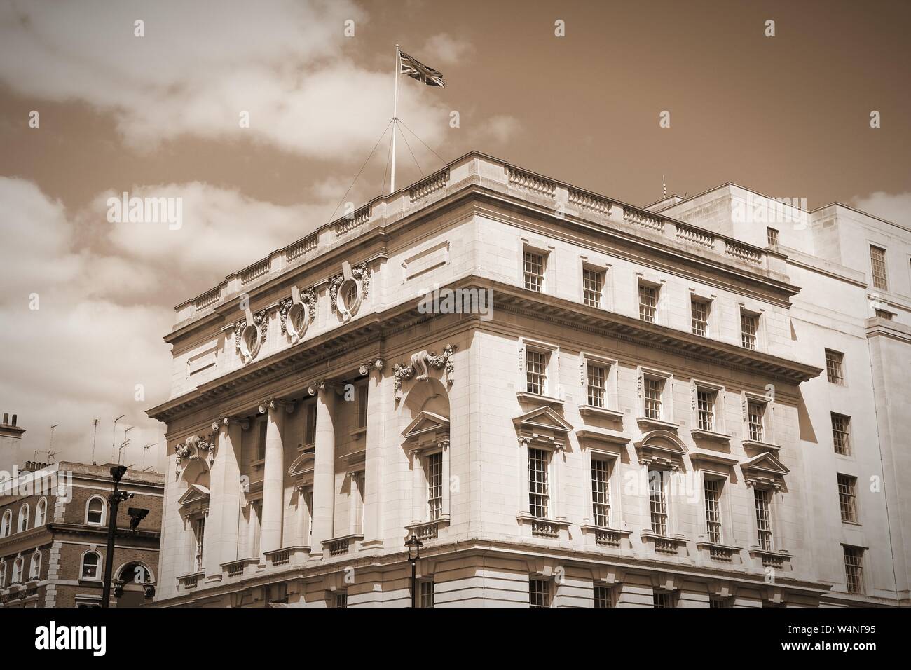 London, UK - governmental building at Whitehall. British flag. Sepia tone - filtered vintage photo style. Stock Photo