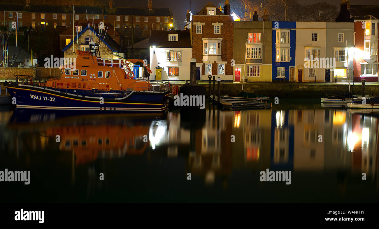 A night shot of the Weymouth RNLI lifeboat moored in its regualr moorings next to Weymouth Lifeboat Station Stock Photo
