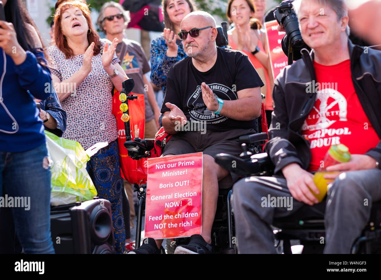Liverpool, UK. July 24, 2019. Following today's proceedings in London where Boris Johnson took over from Theresa May as the Prime Minister of the United Kingdom, a rally was held in Williamson Square in Liverpool, north west England, against Boris Johnson becoming Prime Minster. Around 100 people attended, some holding banners and placards referring to the new Prime Minster, whilst some participants made speeches. Credit: Christopher Middleton/Alamy Live News Stock Photo