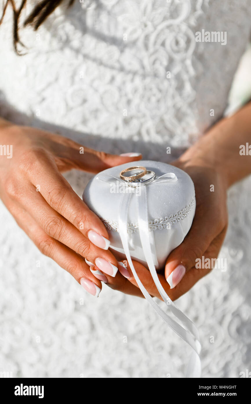 Closeup Of Gold Wedding Rings Tied With A White Silk Ribbon To A Jewelry Box In The Hands Of The Bride Selective Focus Stock Photo Alamy