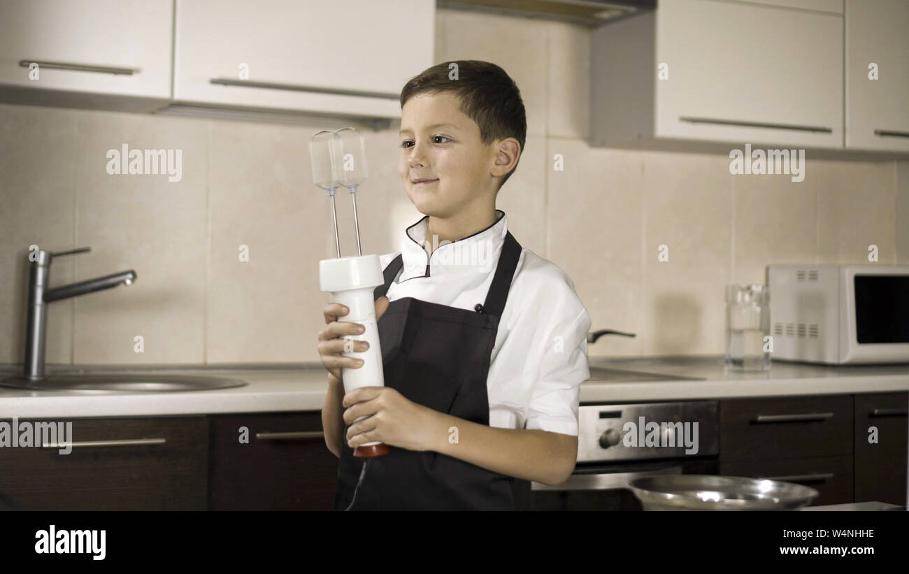 The little boy in a suit of the cook. Baby make dinner in chef suit Stock Photo